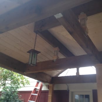 On Demand Construction - a wooden porch with a lantern hanging from the ceiling - General Contractors Near Me On Demand Construction - a wooden porch with a lantern hanging from the ceiling - General Contractors Near Me