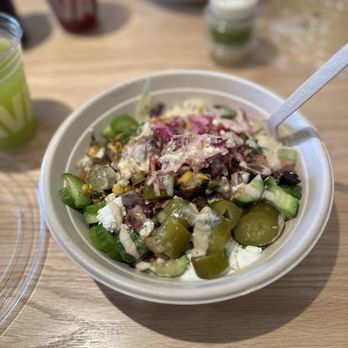 CAVA - a bowl of salad and a drink on a table - Mediterranean Near Me - Sherman Oaks, California