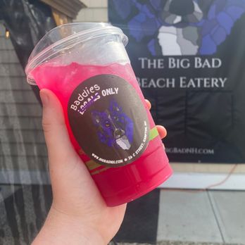 The Big Bad Beach Eatery - a hand holding a cup of pink drink - Barbeque Near Me - Hampton, New Hampshire The Big Bad Beach Eatery - a hand holding a cup of pink drink - Barbeque Near Me - Hampton, New Hampshire