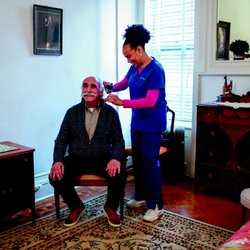 VNS Health - One of our team members providing personal care for a patient.