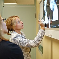 Melnik L Irina, MD - Comprehensive Spine & Sports - Dr. Irina Melnik reviewing a patient's diagnostic images.