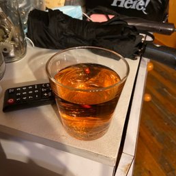 a glass of whiskey and a remote control a glass of whiskey and a remote control