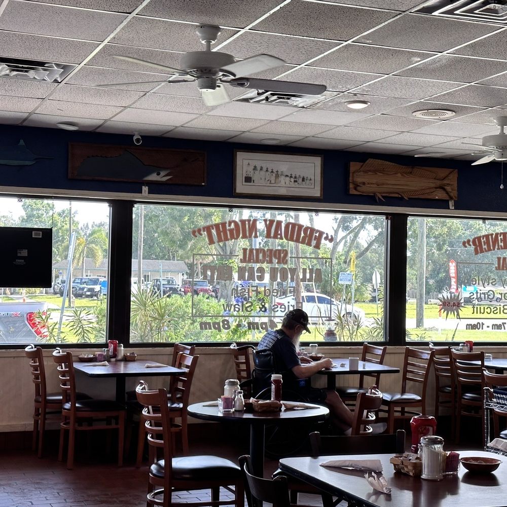 Izzy's Diner - a woman sitting at a table - Diners Near Me - Palm Bay, Florida Izzy's Diner - a woman sitting at a table - Diners Near Me - Palm Bay, Florida