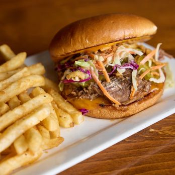 Cedar Door Patio Bar & Grill - BBQ Brisket Sandwich with housemade slaw and Tajin fries - American Near Me - Austin, Texas Cedar Door Patio Bar & Grill - BBQ Brisket Sandwich with housemade slaw and Tajin fries - American Near Me - Austin, Texas