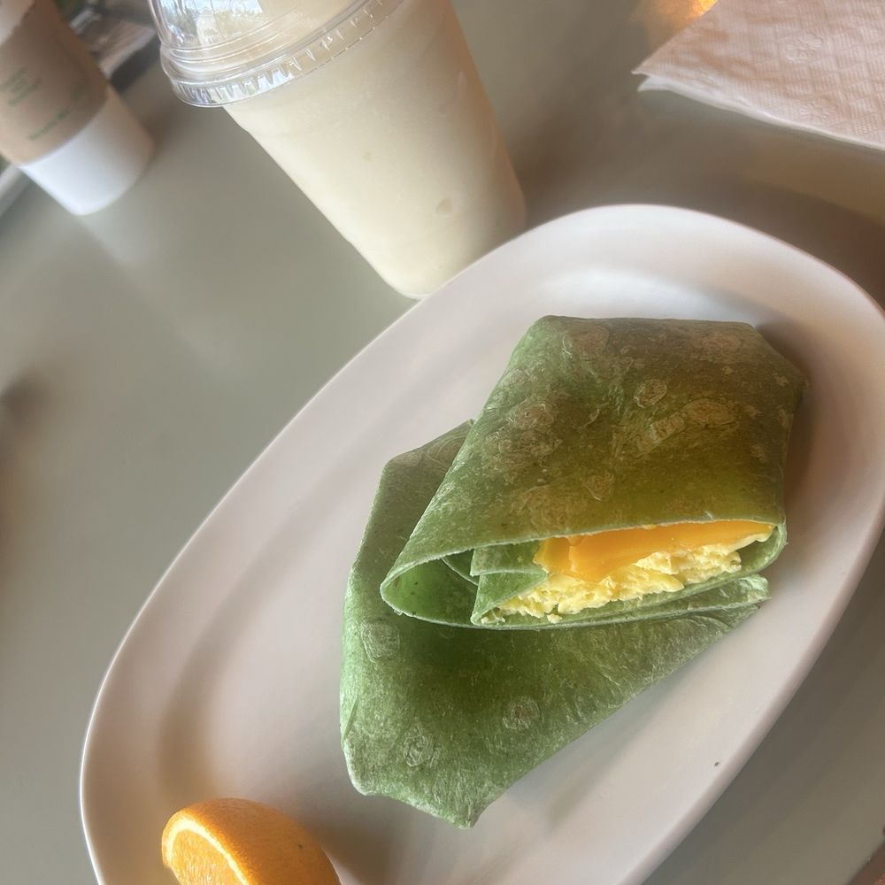 Egg and cheese wrap with a pina colada fruit smoothie Egg and cheese wrap with a pina colada fruit smoothie