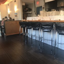 Open kitchen with a bar seating in front Open kitchen with a bar seating in front