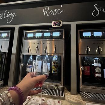 Uva Wine Bar - a person holding a glass of wine - Wine Bars Near Me - Plymouth, Massachusetts