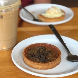 a pastry on a plate and a cup of coffee a pastry on a plate and a cup of coffee