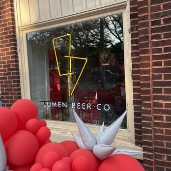 Lumen Beer - red balloons in front of a window - Brewpubs Near Me - Omaha, Nebraska