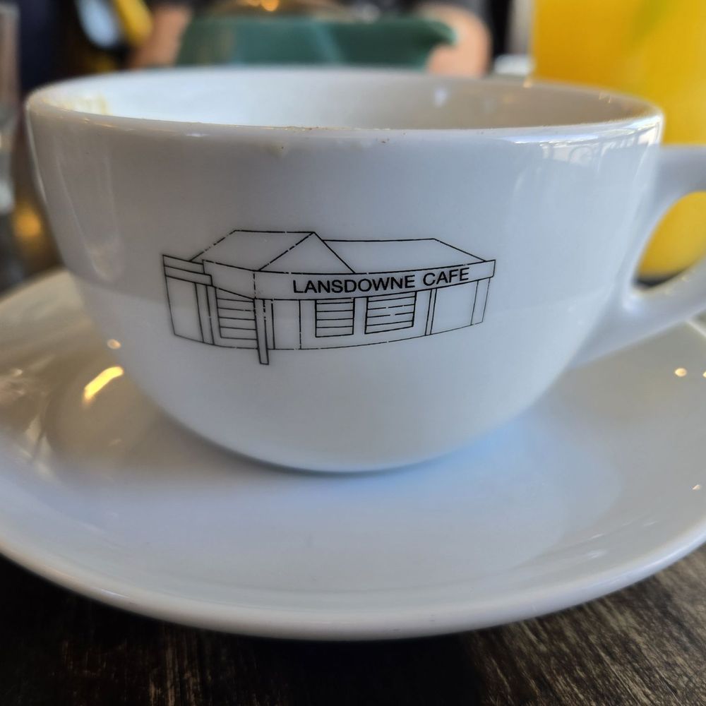 Lansdowne Cafe - A coffee mug with their logo. - Cafes Near Me - West Hobart, TAS
