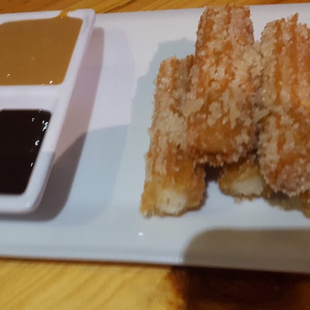 Gauchos Parrillada Argentina - Churros with chocolate and dulce de leche dipping sauces. - Argentine Near Me - San Juan, Puerto Rico Gauchos Parrillada Argentina - Churros with chocolate and dulce de leche dipping sauces. - Argentine Near Me - San Juan, Puerto Rico