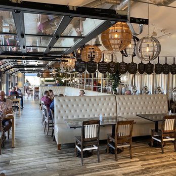 The Grist - a restaurant with a long table and chairs - Breweries Near Me - Niagara-on-the-Lake, Ontario The Grist - a restaurant with a long table and chairs - Breweries Near Me - Niagara-on-the-Lake, Ontario
