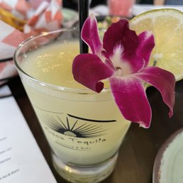 a drink with a purple flower a drink with a purple flower