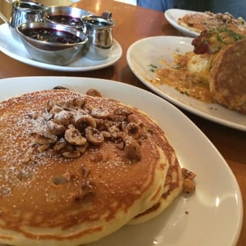 Plums Cafe - 1 order of hazelnut pancakes split into two portions for us! And an order of the Plum's Biscuit & Gravy. (Both $15 each) - Breakfast & Brunch Near Me - Costa Mesa, California