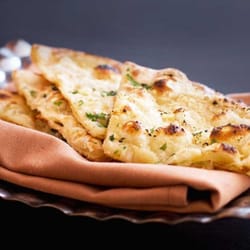 Tiffin Elkins Park - Naan Flat bread baked in a tandoor...Choose from Classic, Chili, Garlic, Onion, Lachha Paratha, Cheese Kulch, and Peshawari varieties.