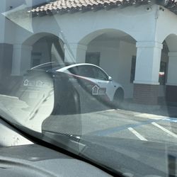 Barlow Realty - A car of theirs parked on a red curb