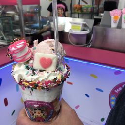 a hand holding a cup of ice cream a hand holding a cup of ice cream