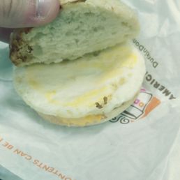 a hand holding a half eaten sandwich