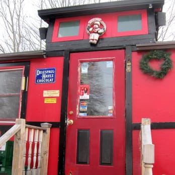 Bagel Caboose - a red caboose with wreaths on the door - Bagels Near Me - Kittery, Maine