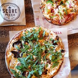 two pizzas on a table two pizzas on a table
