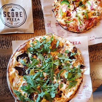 Score Pizza - two pizzas on a table - Pizza Near Me - Newmarket, Ontario Score Pizza - two pizzas on a table - Pizza Near Me - Newmarket, Ontario