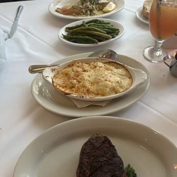 Keith Youngs Steakhouse - Fillet with au gratin potatoes. Red fish with lump crab meat and cream sauce - Steakhouses Near Me - Madisonville, Louisiana Keith Youngs Steakhouse - Fillet with au gratin potatoes. Red fish with lump crab meat and cream sauce - Steakhouses Near Me - Madisonville, Louisiana