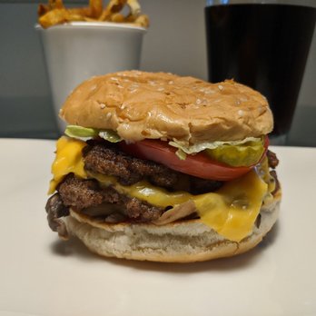 Five Guys - My happy meal. Yummy cheeseburger with 2 patties, topped with loads of veggie goodness. Incredible fries in the background. - Burgers Near Me - Northville, Michigan