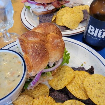 Good Harbor Grill - Turkey Avocado sandwich with bacon in back. Half a turkey sandwich and a cup of potato leek soup in foreground. - Breakfast & Brunch Near Me - Glen Arbor, Michigan