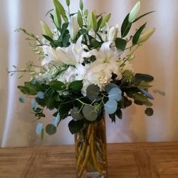 Mora's Floral Design Studio - This is an Alluring  traditional style involving white lilies, that have such a nice fragrance and silver dollar eucalyptus!  Classic!