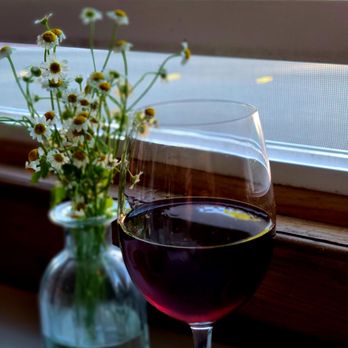 Hazel - a glass of wine next to a vase of flowers - Pizza Near Me - Occidental, California