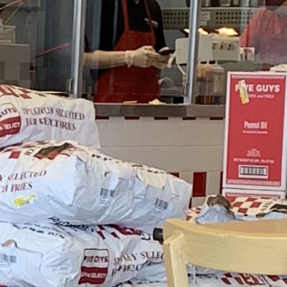 Touching phone with food gloves, then puts burgers together with same gloves. Um, what?! How is this food safety?