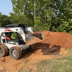 Martel's Landscaping - About to spread all this red dirt