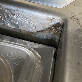 Pizza World - a dirty kitchen sink with a spatula - Pizza Near Me - Belleville, Illinois Pizza World - a dirty kitchen sink with a spatula - Pizza Near Me - Belleville, Illinois