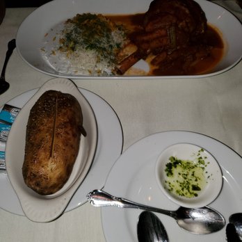 Cafe Renaissance - Long shot of the lamb shank and baked potato - Mediterranean Near Me - Waite Park, Minnesota