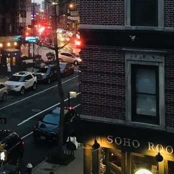 SoHo Room - a busy city street at night - American Near Me - New York, New York