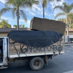 DURING: The guys safely securing the two couches onto their truck. DURING: The guys safely securing the two couches onto their truck.