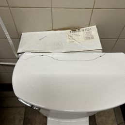 Toilet is being held together by a box placed behind it. 0.0