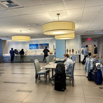 The Club - a group of people sitting at tables - Airport Lounges Near Me - Las Vegas, Nevada