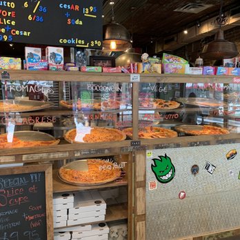 Slice + Soda - a display of pizzas in a store - Pizza Near Me - Montreal, Quebec Slice + Soda - a display of pizzas in a store - Pizza Near Me - Montreal, Quebec