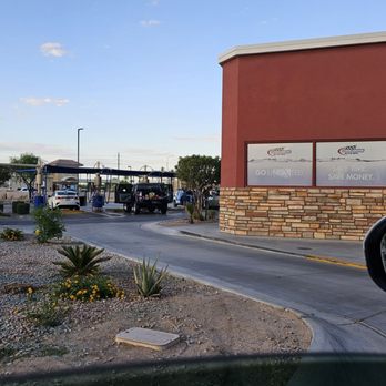 Cobblestone Auto Spa Express - A parking lot with a drive-thru area is visible, with a red building and a side mirror of a car in the foreground, in a desert-like setting. - Car Wash Near Me - Chandler, Arizona