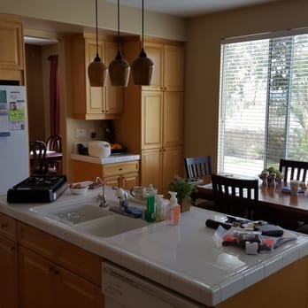 Universal Home Design - Before Universal Home Design: tile countertops, shallow sink, deteriorating faucet, dated appliances, parquet floor - General Contractors Near Me