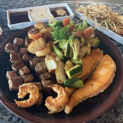 Steak, salmon, shrimp, scallops, veggies, fried rice, sauces and soda