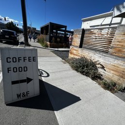 a coffee food sign on a sidewalk