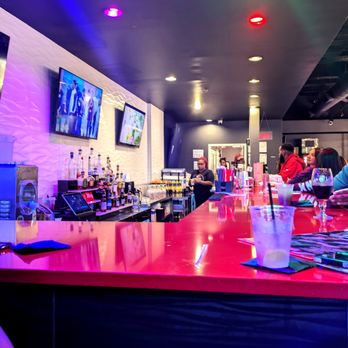 Encore Rouge - a bar with people sitting at the bar - New American Near Me - Birmingham, Alabama