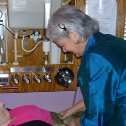 Joyce Long Wellness Institute - Joyce Long teaching a client about Colon Hydrotherapy