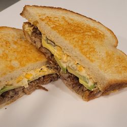 The Hummingbird - Street Corn Sammy - braised pork, pepper-jack, spicy corn & pepper spread, sliced avocado on sourdough