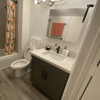 HY Construction - After guest bathroom with new vanity, mirror, vinyl plank flooring - General Contractors Near Me HY Construction - After guest bathroom with new vanity, mirror, vinyl plank flooring - General Contractors Near Me