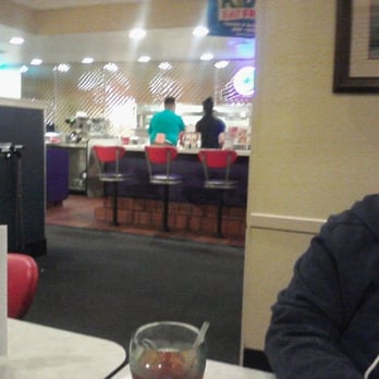 Denny's - Manager in the Green shirt with the orange book placed in the back of his pants touching his ass! He takes orders with that book - Diners Near Me - Marina, California