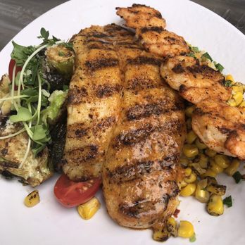 California Fish Grill - Grilled Swai Cajun style on a bed of fire roasted corn and grilled Brussels sprouts. - Seafood Near Me - Citrus Heights, California