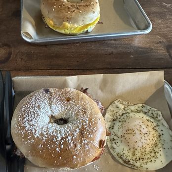 Stompin' Grounds Coffee House - Front: MB3 with over easy egg on the side. Back: Bacon, egg, and cheese on everything bagel - Coffee & Tea Near Me - Hendersonville, Tennessee Stompin' Grounds Coffee House - Front: MB3 with over easy egg on the side. Back: Bacon, egg, and cheese on everything bagel - Coffee & Tea Near Me - Hendersonville, Tennessee